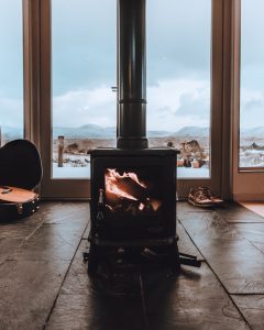 Stove in Glasgow holiday home with french doors behind it looking on to stunning views