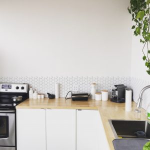 White and wood kitchen designed by Home Improvement Contractor